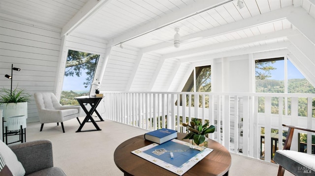 sunroom / solarium with vaulted ceiling with beams, a ceiling fan, and a healthy amount of sunlight