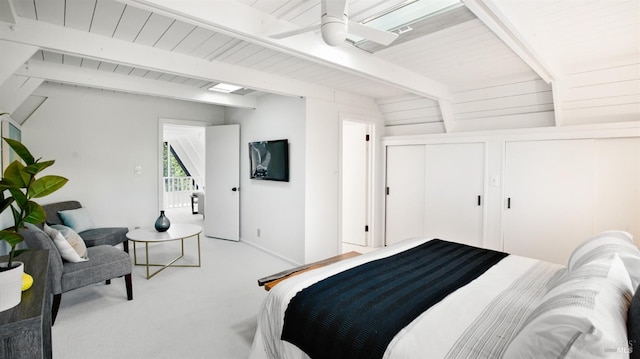 carpeted bedroom featuring lofted ceiling with beams and a ceiling fan