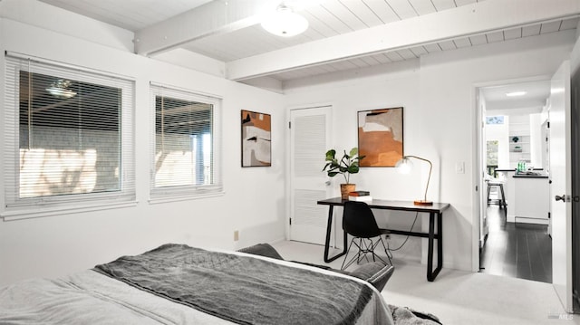 bedroom featuring wooden ceiling, beam ceiling, and wood finished floors