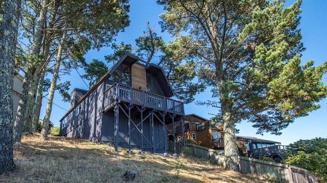 back of property featuring fence and a wooden deck