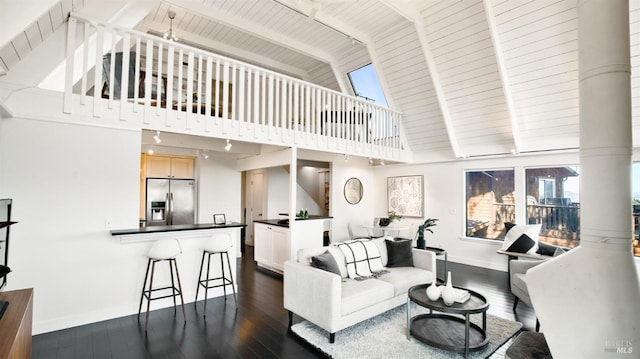 living area with beamed ceiling, dark wood finished floors, wood ceiling, and baseboards