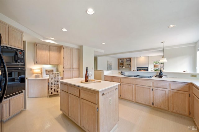 kitchen with black appliances, recessed lighting, a kitchen island, and light brown cabinetry