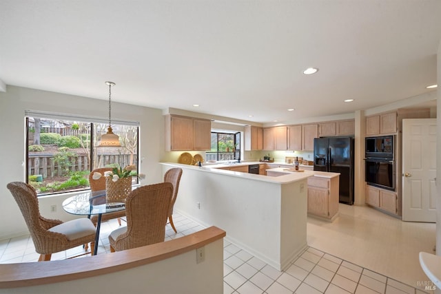 kitchen featuring recessed lighting, light countertops, light brown cabinetry, a peninsula, and black appliances