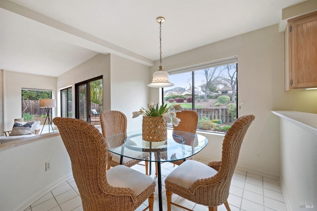 dining room featuring plenty of natural light, light tile patterned flooring, and baseboards