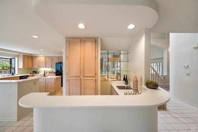 kitchen with light tile patterned floors, recessed lighting, light countertops, light brown cabinets, and black appliances