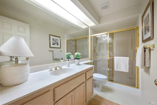 bathroom featuring toilet, a stall shower, visible vents, and vanity