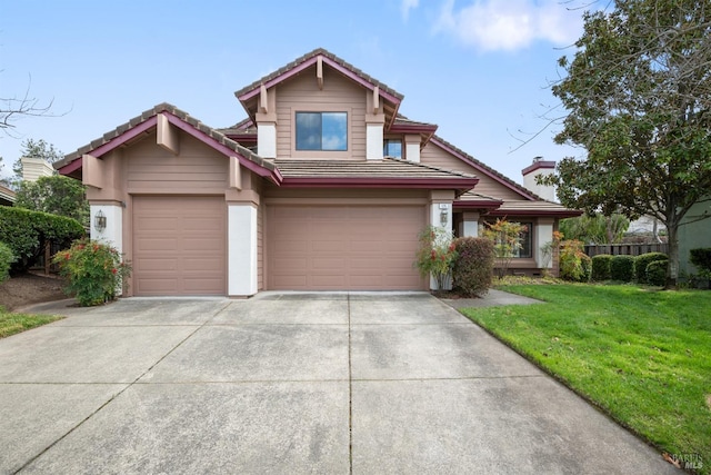 view of front of house featuring a garage, a tile roof, a front lawn, and concrete driveway