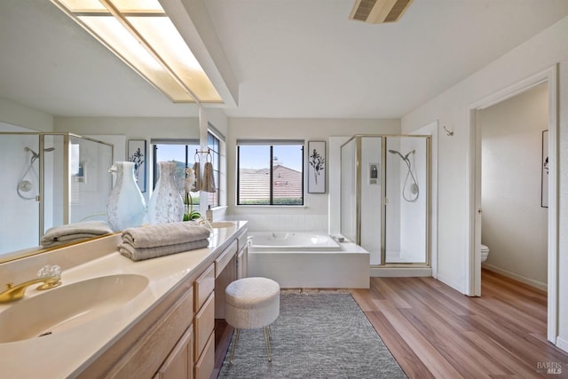 bathroom featuring a garden tub, double vanity, visible vents, a sink, and a shower stall