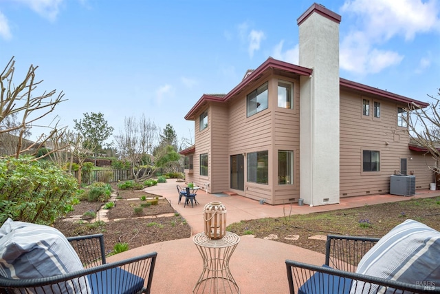 rear view of property featuring a chimney, crawl space, fence, cooling unit, and a patio area