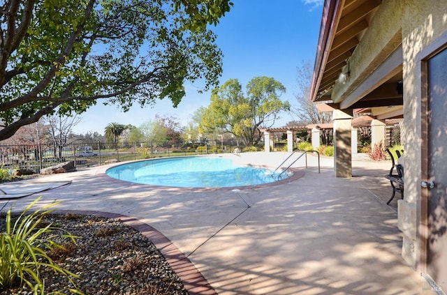 pool featuring fence, a pergola, and a patio