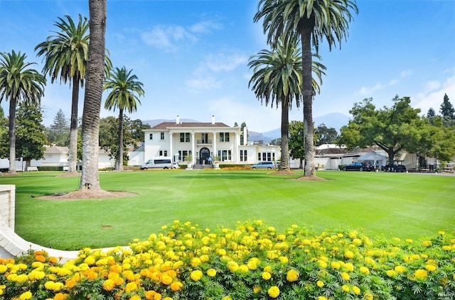 view of property's community with a lawn