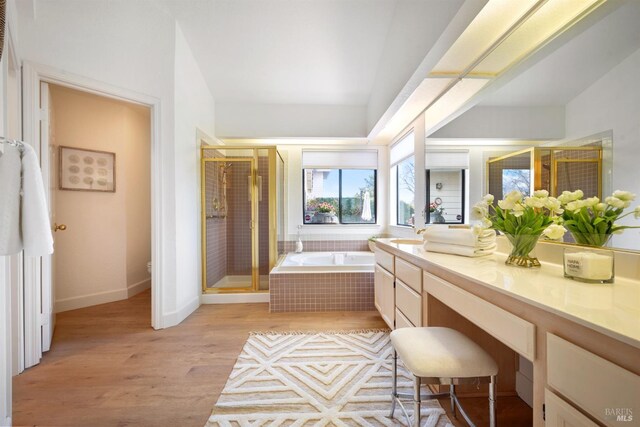 full bathroom featuring a garden tub, toilet, vanity, a shower stall, and wood finished floors