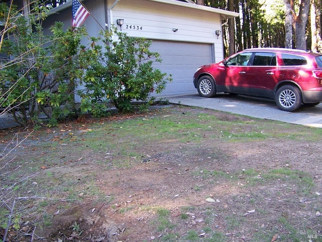 exterior space featuring a garage and concrete driveway