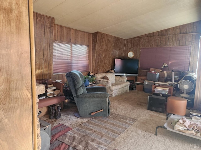 carpeted living area featuring wooden walls and lofted ceiling