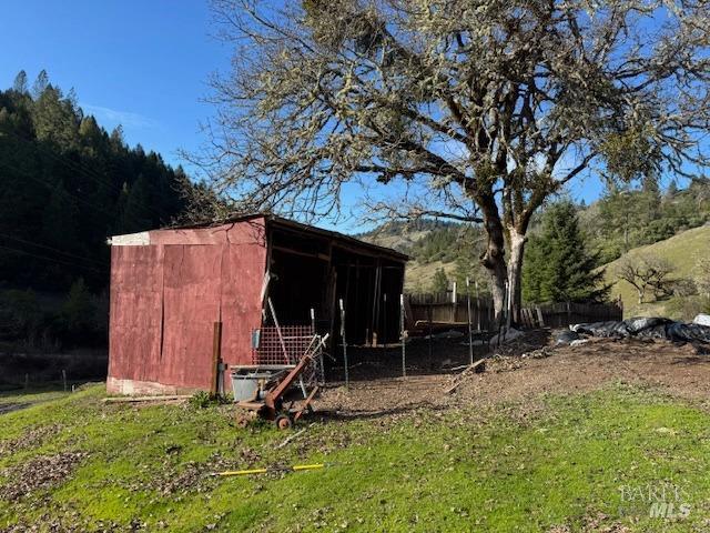 view of pole building with fence