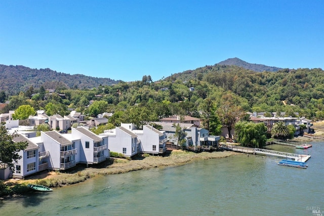 bird's eye view featuring a residential view, a view of trees, and a water and mountain view