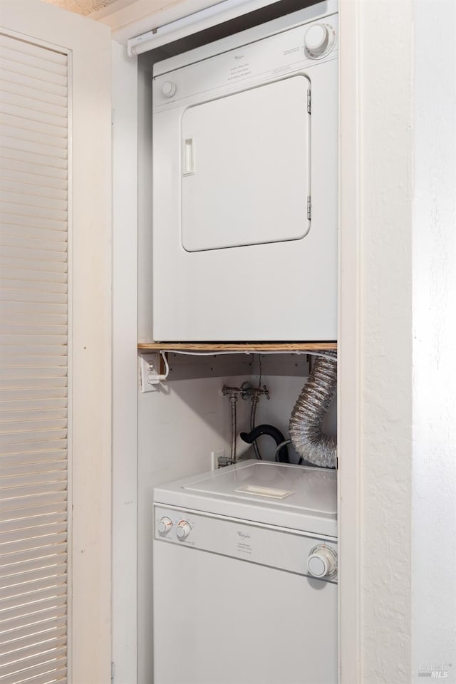 laundry area with stacked washer and dryer and laundry area