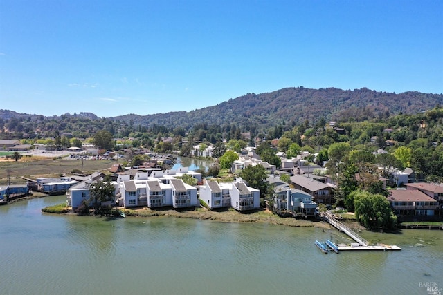 bird's eye view featuring a residential view, a forest view, and a water and mountain view