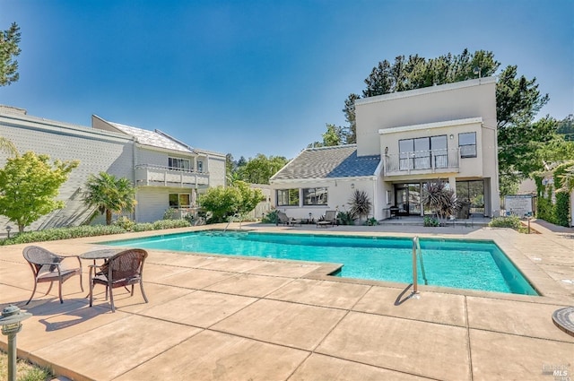 outdoor pool with a patio area