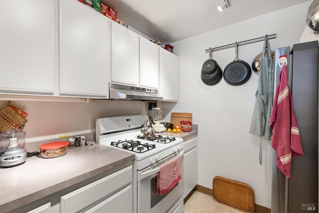 kitchen with baseboards, under cabinet range hood, white cabinetry, and white range with gas stovetop