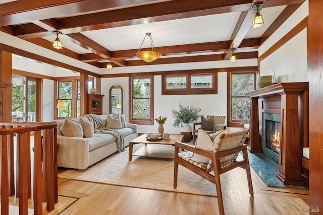 living area featuring light wood-type flooring, plenty of natural light, a premium fireplace, and beam ceiling