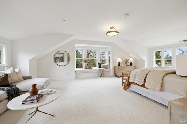 carpeted bedroom with lofted ceiling and visible vents