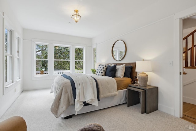 carpeted bedroom featuring baseboards