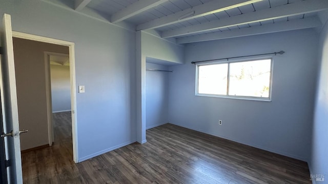 unfurnished bedroom featuring wood ceiling, baseboards, a closet, beamed ceiling, and dark wood finished floors