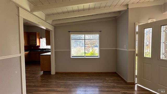 foyer entrance with lofted ceiling with beams, dark wood finished floors, and wood ceiling