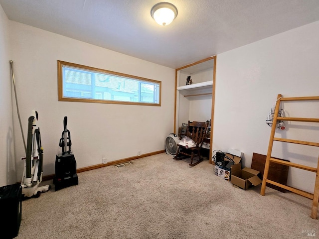 interior space featuring carpet floors, visible vents, and baseboards