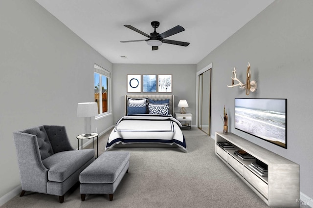 carpeted bedroom with a closet, a ceiling fan, and baseboards