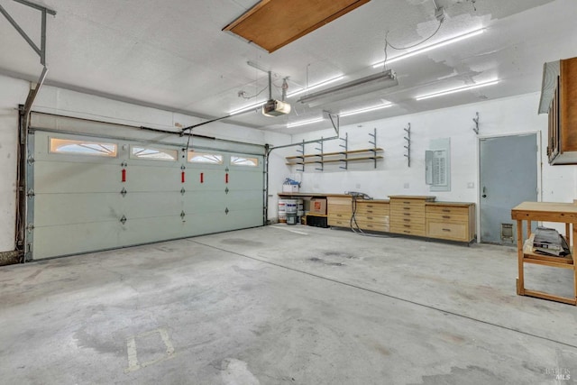 garage with a workshop area and a garage door opener