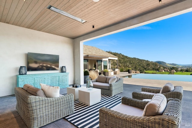 view of patio with a mountain view and outdoor lounge area