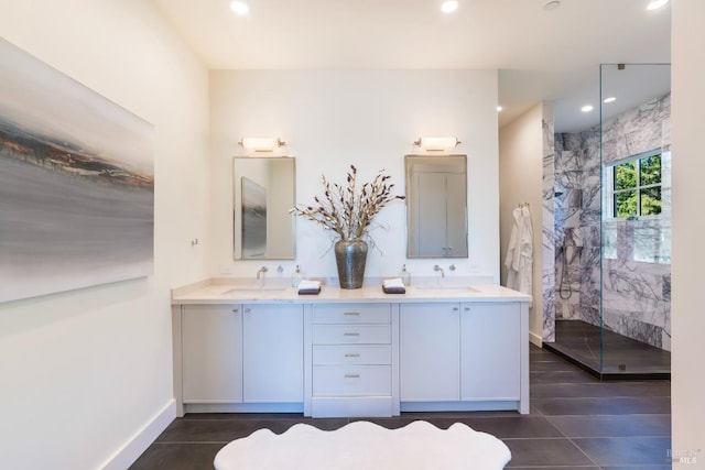 bathroom featuring double vanity, a sink, a marble finish shower, and recessed lighting