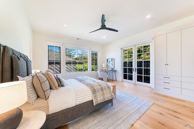 bedroom with light wood-style floors, recessed lighting, multiple windows, and french doors