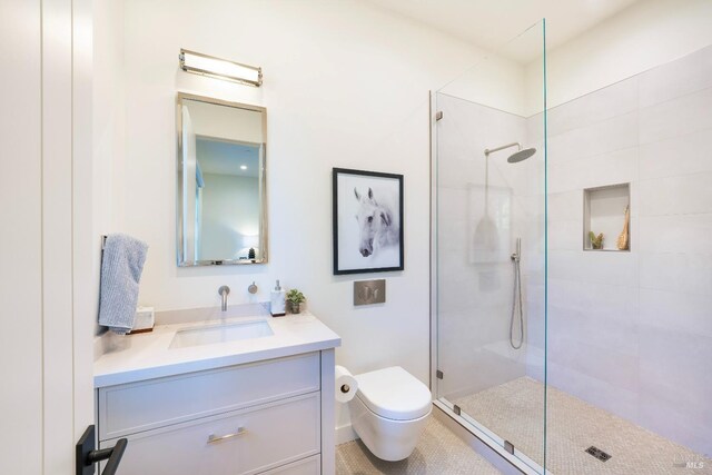 bathroom featuring vanity, toilet, and walk in shower