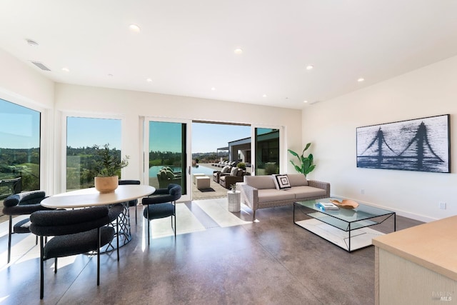 living room featuring finished concrete floors, recessed lighting, visible vents, and baseboards