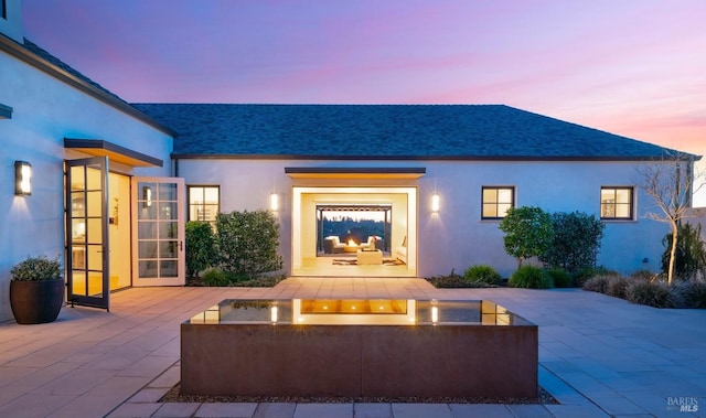 view of patio terrace at dusk