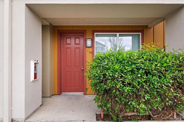 entrance to property featuring stucco siding