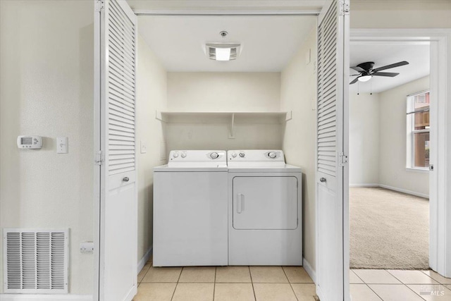 laundry room with light tile patterned floors, laundry area, washing machine and clothes dryer, and visible vents