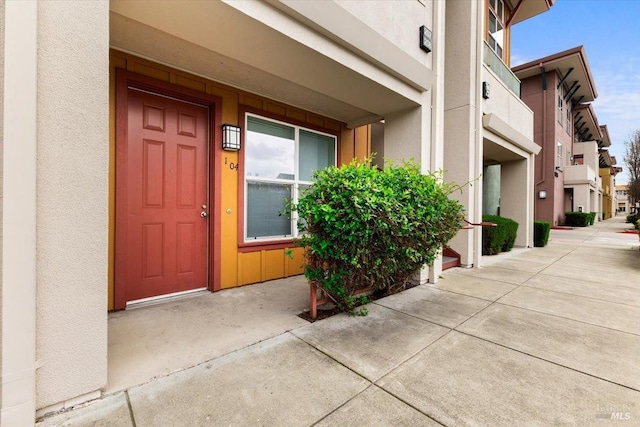 property entrance with stucco siding