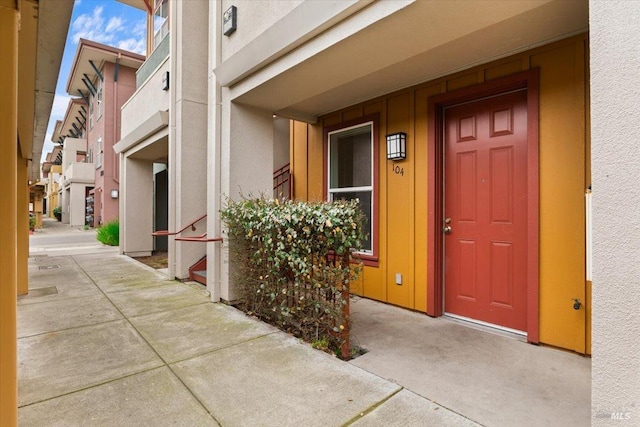 entrance to property featuring stucco siding