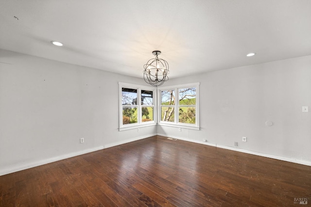 unfurnished room featuring visible vents, baseboards, hardwood / wood-style floors, a chandelier, and recessed lighting