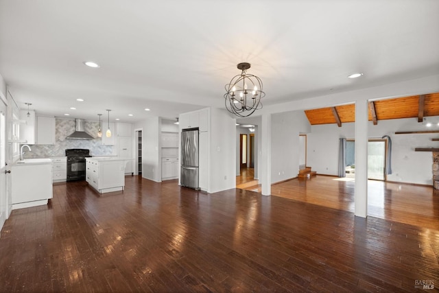 unfurnished living room with lofted ceiling with beams, wooden ceiling, hardwood / wood-style flooring, a sink, and an inviting chandelier