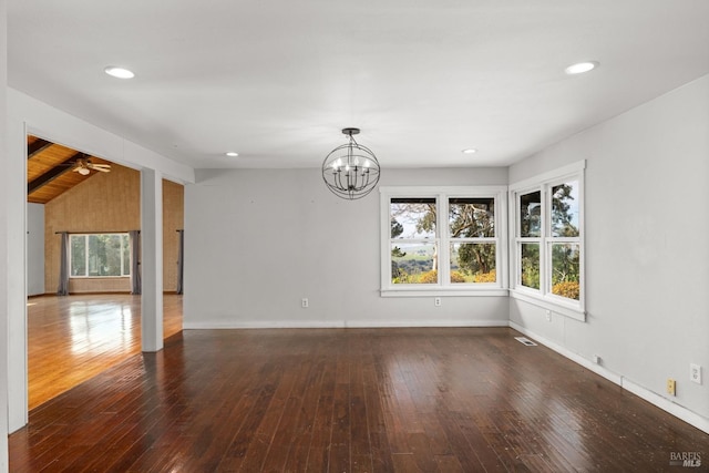 interior space with baseboards, visible vents, vaulted ceiling, and hardwood / wood-style floors