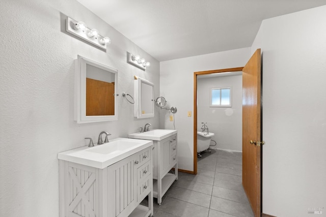 bathroom featuring two vanities, a sink, and tile patterned floors