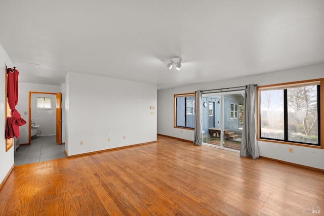 spare room with light wood finished floors and baseboards