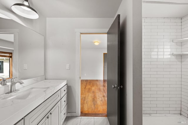 bathroom with a stall shower and vanity