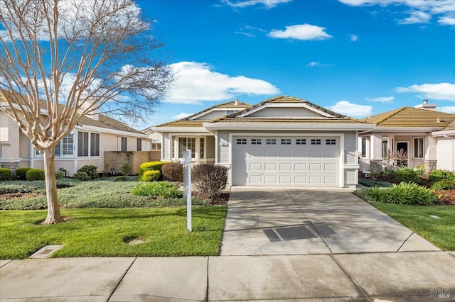 ranch-style house with a front yard, a tiled roof, an attached garage, and driveway