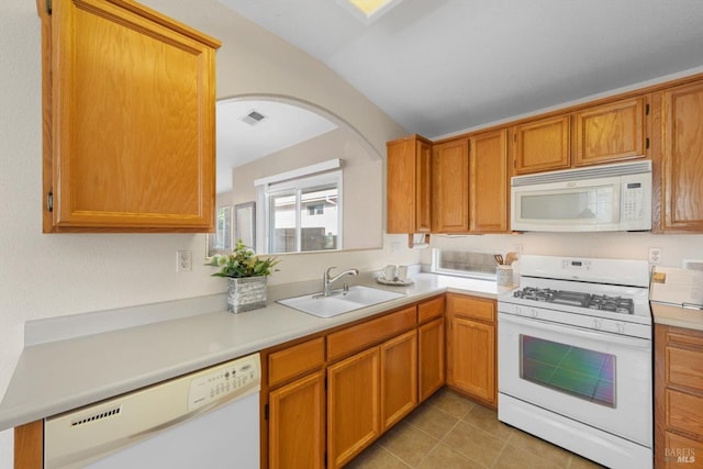 kitchen with visible vents, light countertops, light tile patterned floors, white appliances, and a sink